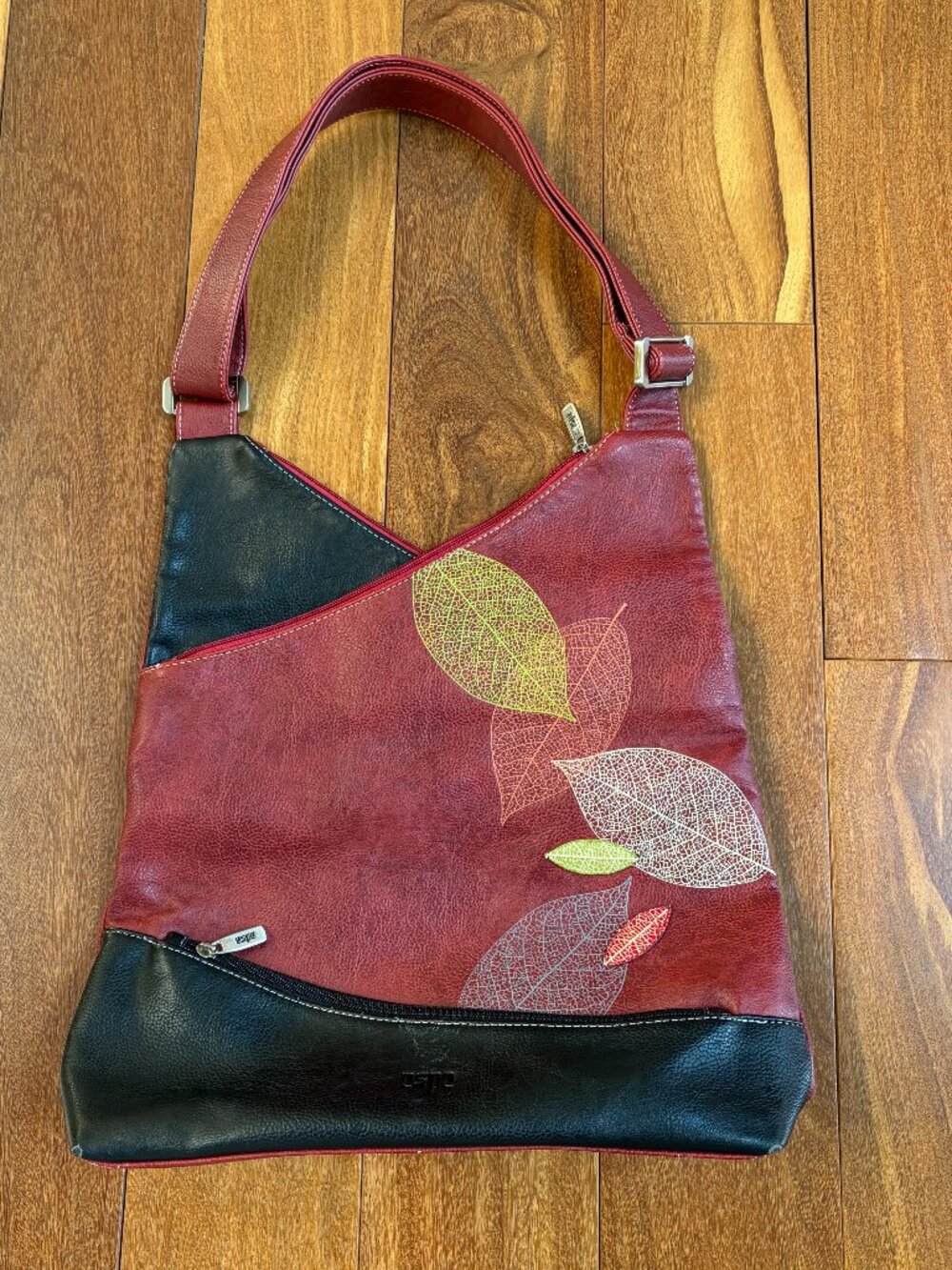 Espe black and wine faux leather panel handbag with artistic skeleton leaf desig